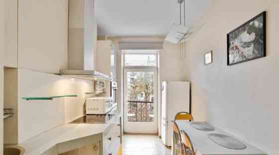 A two-room apartment with separate rooms, a balcony, and a parking space.  The apartment is fully fu Рига