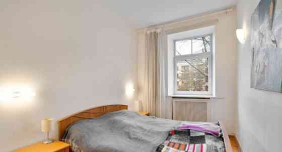 A two-room apartment with separate rooms, a balcony, and a parking space.  The apartment is fully fu Рига