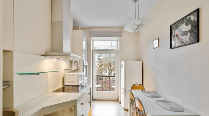 A two-room apartment with separate rooms, a balcony, and a parking space.  The apartment is fully fu Рига - изображение 3