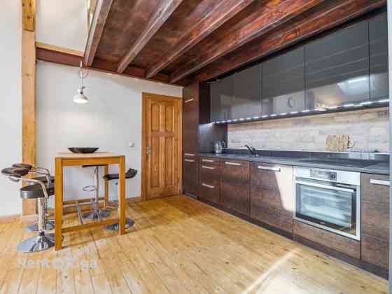 Эксклюзивная двухуровневая мансардная квартира с частной террасой на крыше  в Рига