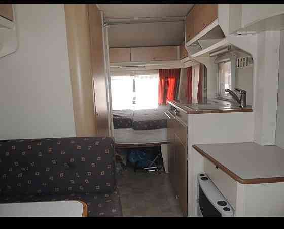 Прекрасный и очень ухоженный прицеп KIP 440 Grey-Line с двумя зонами отдыха, тентом, 3-точечным... Rīga