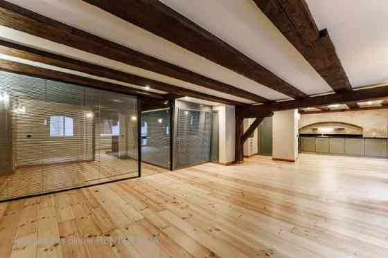 A stylish office in a renovated building in Rigas Old Town. It features preserved original wooden be Рига