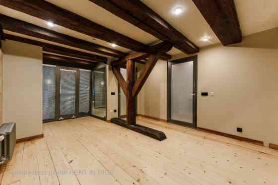 A stylish office in a renovated building in Rigas Old Town. It features preserved original wooden be Рига