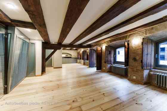 A stylish office in a renovated building in Rigas Old Town. It features preserved original wooden be Рига