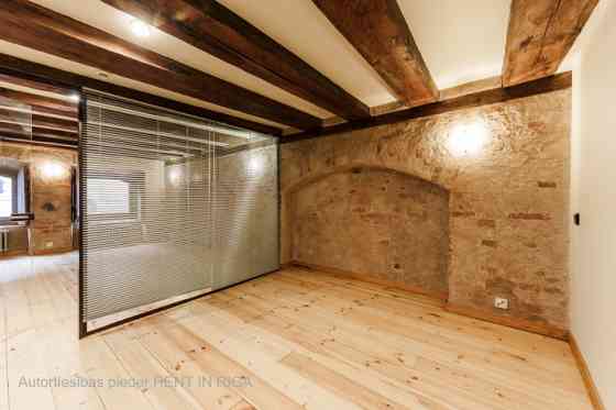 A stylish office in a renovated building in Rigas Old Town. It features preserved original wooden be Рига