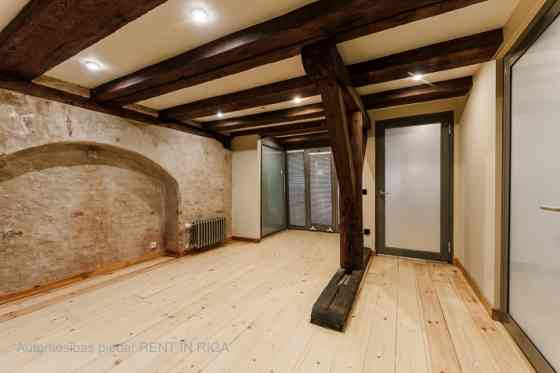 A stylish office in a renovated building in Rigas Old Town. It features preserved original wooden be Рига