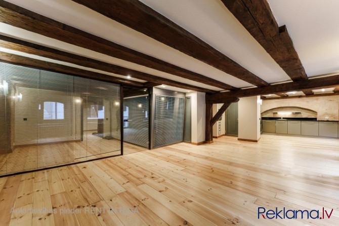 A stylish office in a renovated building in Rigas Old Town. It features preserved original wooden be Рига - изображение 1