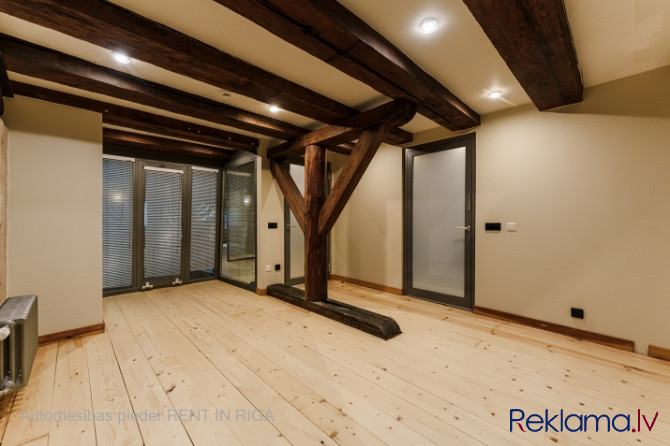 A stylish office in a renovated building in Rigas Old Town. It features preserved original wooden be Рига - изображение 6