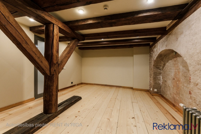 A stylish office in a renovated building in Rigas Old Town. It features preserved original wooden be Рига - изображение 7