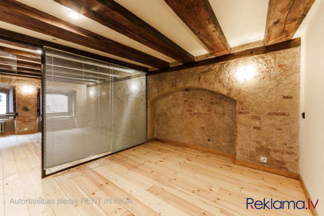 A stylish office in a renovated building in Rigas Old Town. It features preserved original wooden be Рига - изображение 2