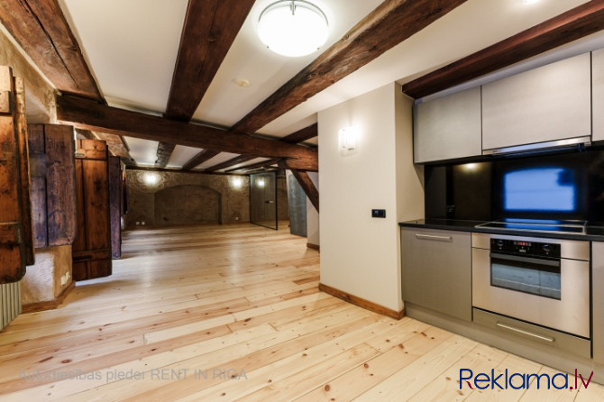 A stylish office in a renovated building in Rigas Old Town. It features preserved original wooden be Рига - изображение 3