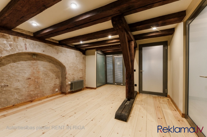 A stylish office in a renovated building in Rigas Old Town. It features preserved original wooden be Рига - изображение 5